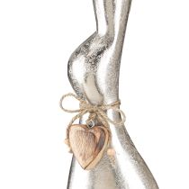 Artikel Dekorativt kaninsilver på träbotten – Elegant påskfigur med hjärthänge H60cm