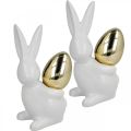 Floristik24 Kaniner med guldägg, keramiska kaniner till påsk ädelvit, gyllene H13cm 2st